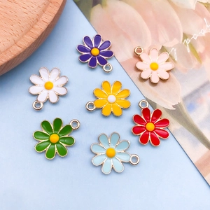 Macro view of colorful enamel daisy charms in seven vibrant shades for DIY jewelry making