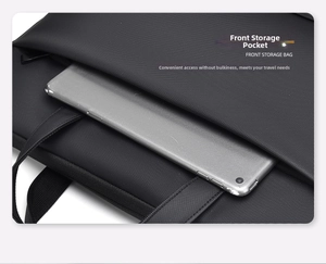 Detail view of the front storage pocket with twill texture on a black laptop bag