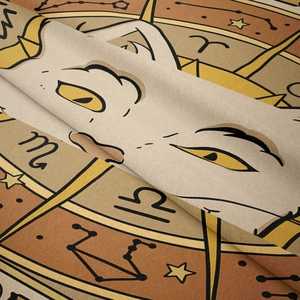 Macro shot of bohemian tapestry fabric showing zodiac symbols and soft cat eye print