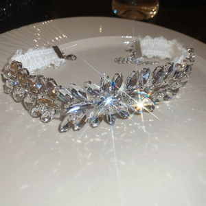Close-up of elegant lace choker with shimmering crystals and floral rhinestone details