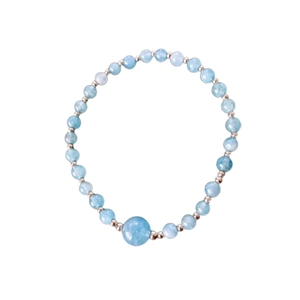 Elegant beaded blue stone bracelet with metal accents on a clean white background