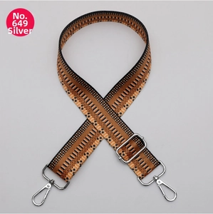 Detail of silver metal buckle and adjustable clasp on woven geometric wide bag strap