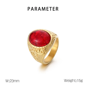 Close-up of vintage Viking style ring with red gemstone and detailed metal texture