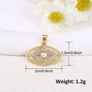 Detail of gold-plated evil eye pendant with crystals and pearl, showing 2cm x 1.3cm size