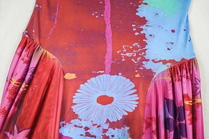 Close-up of abstract floral print and pleated stitching on a bohemian long-sleeved dress