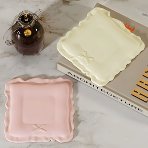 Square wavy silicone coaster mold set with bow ties on marble table with teapot decor