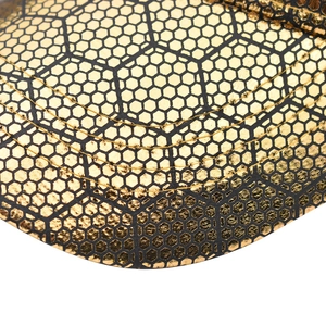 Detail of golden baseball cap brim with black honeycomb texture and five-row stitching