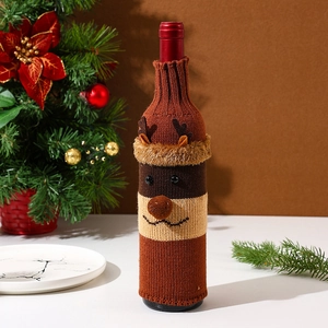 Close-up of a brown knitted reindeer wine bottle cover with detailed 3D antlers and nose