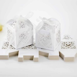 Laser-cut white heart wedding favor boxes with ribbons in flat and assembled views