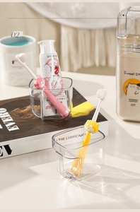 Detail of portable kids toothbrush set with clear storage cup and easy-grip handle