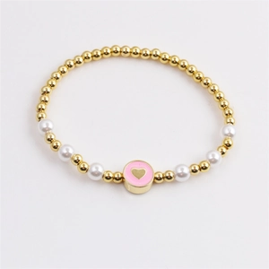 Chic gold-plated bead bracelet with elegant white pearls and a pink enamel heart charm
