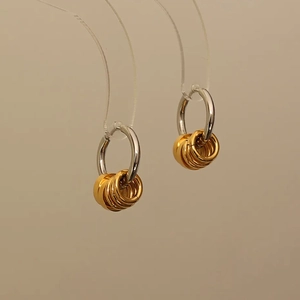 Two-tone stainless steel hoop earrings with polished silver base and five gold dangles