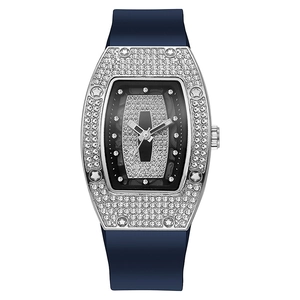 Macro detail of tonneau-shaped watch dial with sparkling rhinestones and silver casing