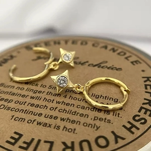 Elegant gold star drop earrings with clear zircon crystals on minimalist hoops