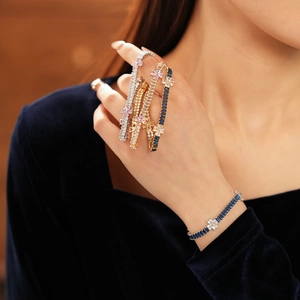 Close-up of elegant zircon flower bracelet on wrist with rectangular blue gemstones