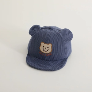 Detail der Baby-Cordmütze mit süßer Bärenstickerei und dekorativen Ohren in Blau