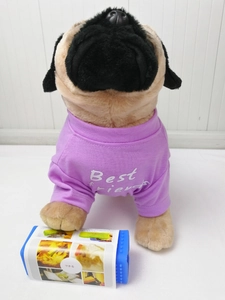 Blue rectangular kitchen tool with instructions shown with a plush pug dog model