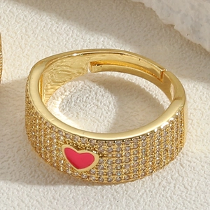 Detail of 14K gold plated ring with micro-pave zircons and pink enamel heart center