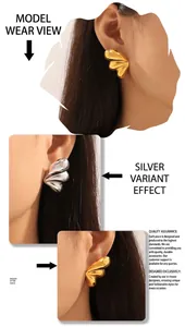 Close-up of minimalist fan-shaped gold and silver earrings with polished mirror finish