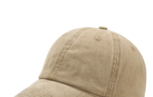 Detailed close-up of khaki washed cotton baseball cap showing fine stitching and texture