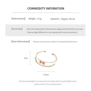 Detailed product card showing a gold open cuff with a pink zircon bow and dimensions
