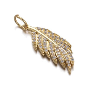 Detailed close-up of golden leaf pendant featuring sparkling pave-set cubic zirconia crystals