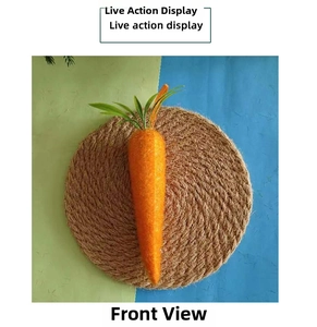 Close-up of artificial Easter carrot with textured orange finish and green leaves