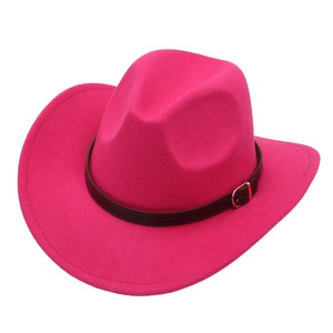 Macro detail of rose red cowboy hat featuring faux leather band and gold buckle detail