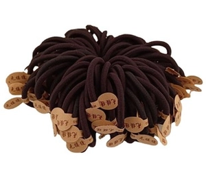 Detail view of dark brown high-elasticity hair ties with seamless knots and paper tags
