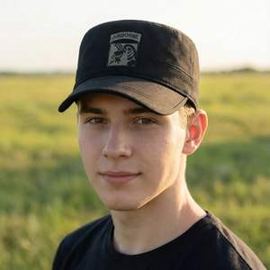 Men's black cotton flat top army cap with embroidered Airborne eagle patch outdoors