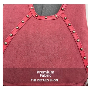 Detail view of pink suede bag featuring sun embossing and silver metallic studs
