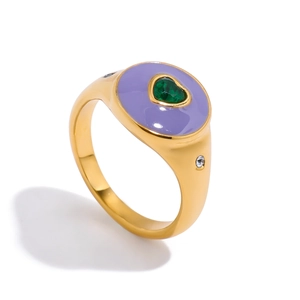 Close-up of golden ring with purple enamel and green heart gemstone with zircons