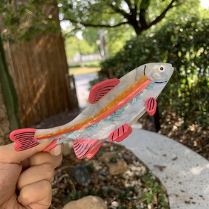 Fish shaped hair claw clip in white acetate with colorful stripes and fin details