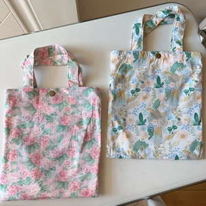 Close-up of floral cotton tote bags featuring vintage copper snap buttons and dual layers