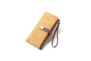 Macro shot of ginger yellow frosted leather wallet with leaf print and gold buckle detail