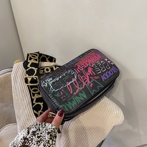 Graffiti print crossbody camera bag with wide shoulder strap and metal hardware