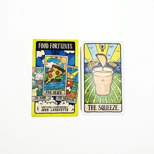 Detailed view of yellow Food Fortunes oracle card box with illustrated The Squeeze card