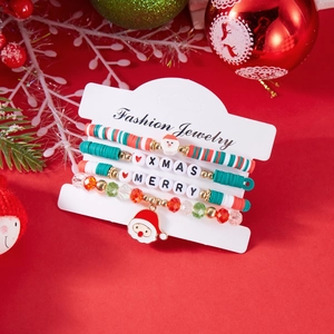 Close-up of Christmas bracelet set with Santa charm, clay beads and XMAS letter charms