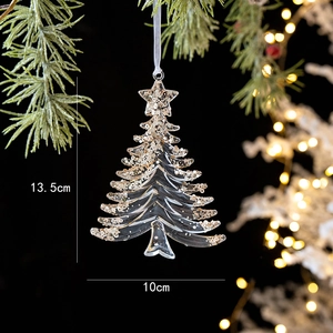 Detail of acrylic Christmas tree ornament with golden sequins on a pine branch