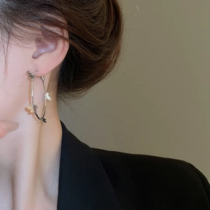 Close-up of bow knot hoop earrings with crystals on a model for a stylish look