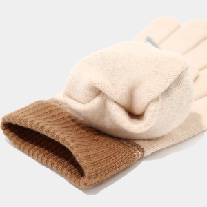 Detail of warm knitted gloves with thick plush lining and contrasting ribbed cuffs