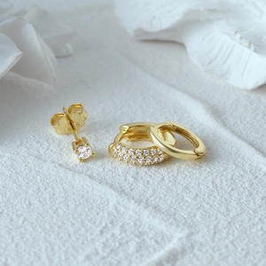 Macro shot of S925 sterling silver gold ear set with cubic zirconia studs and hoops