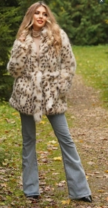 Outdoor shot of stylish leopard print faux fur coat with belted waist and plush texture