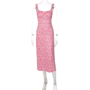 Detail of pink floral midi dress with ruffle straps and pleated chest on white background