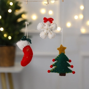 Felt Christmas ornaments set with snowflake, sock and tree shapes in festive warm colors