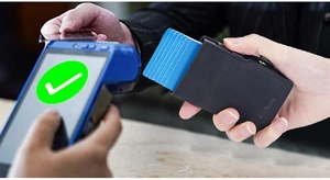Close-up of black RFID leather card holder with automatic pop-up cards in a payment scene