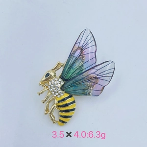 Detail of bee brooch with gold plating, sparkling rhinestones and transparent wings