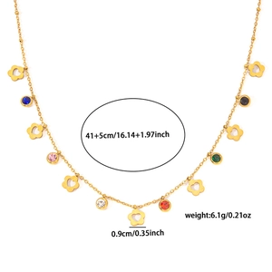 Detail view of gold necklace with colorful round zircons and hollow flower pendants