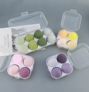 Flat lay of colorful makeup sponge set in clear storage cases with decorative card