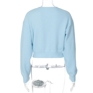 Detail view of light blue knitted cardigan featuring ribbed hem and textured knit back